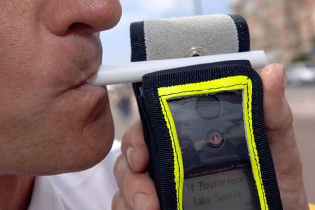 A motorist takes and passes a breath test during a patrol on Saturday night