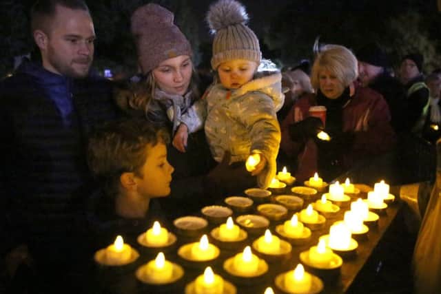 James Shell, Finn Jones, 8, Betzy Shell and Charlotta Shell, 1, with some of the candles