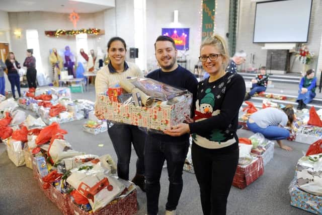 The Waterlooville food bank  handed out 200 boxes of food for Christmas this week at Wecock Church - from left: Katherine Fenwick, Alex Read and Emma Clinnick     Picture: Malcolm Wells (171219-1324)