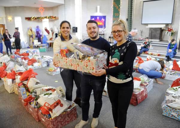 The Waterlooville food bank  handed out 200 boxes of food for Christmas this week at Wecock Church - from left: Katherine Fenwick, Alex Read and Emma Clinnick     Picture: Malcolm Wells (171219-1324)