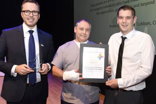 Chief executive of Portsmouth Hospitals NHS Trust Mark Cubbon with Jose Amorim and winner of the CEO Outstanding Achievement Award Craig Dodd. Craig won after performing CPR on Jose who collapsed while working in A&E    Credit  Portsmouth Hospitals NHS Trust