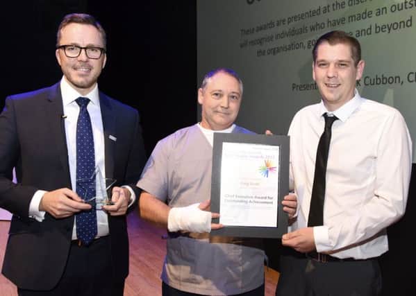 Chief executive of Portsmouth Hospitals NHS Trust Mark Cubbon with Jose Amorim and winner of the CEO Outstanding Achievement Award Craig Dodd. Craig won after performing CPR on Jose who collapsed while working in A&E

    Credit  Portsmouth Hospitals NHS Trust
