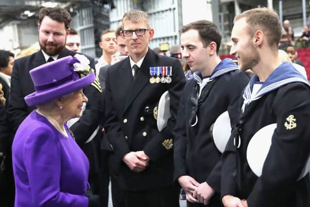 Queen Elizabeth II talks to members of the ship's company, during the commissioning of HMS Queen Elizabeth, Britain's biggest and most powerful warship, into the Royal Navy Fleet at Portsmouth Naval Base Credit: Chris Jackson/PA Wire