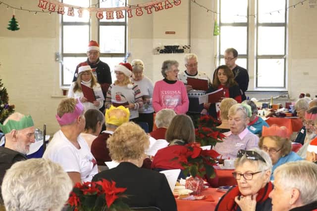 Carol singing at the Eastney and Milton Neighbourhood Police team'sChristmas party for the elderly and vulnerable people of Portsmouth at St Swithuns Church Hall, Waverley Rd, Southsea.Pictures: Neil Marshall (171725-16)