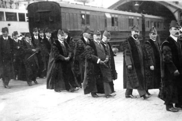 Who might these men be processing at South Railway Jetty? Does anyone recognise the garb?