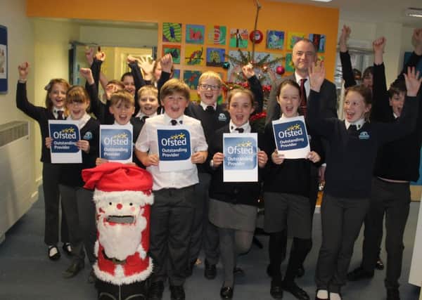 Pupils at Redlands Primary School celebrate their Ofsted report
