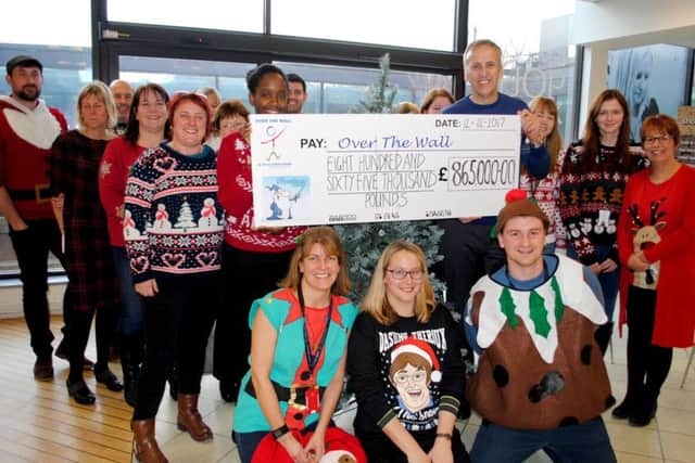 Representatives from Havant charity Over the Wall are presented with a cheque by figures from the Kentown Wizard Foundation