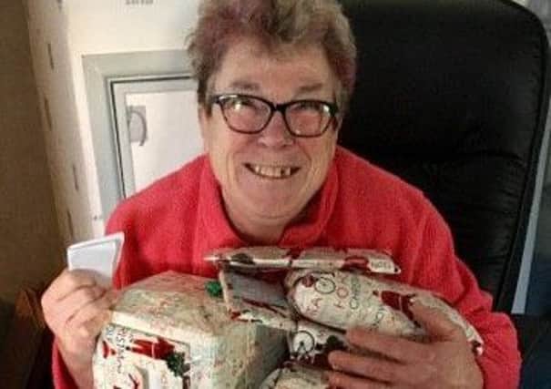Janet Cox smiling as she is reunited with her Christmas presents. Picture: Cathy John