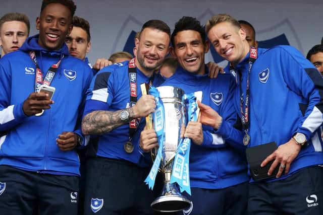 From left to right: Jamal Lowe,  Noel Hunt, Gary Roberts and Carl Baker celebrate Pompey's League Two title success on Southsea Common. Picture: Joe Pepler
