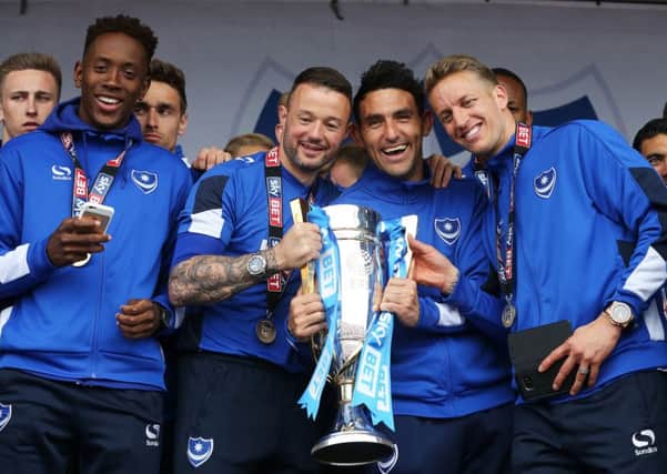 From left to right: Jamal Lowe,  Noel Hunt, Gary Roberts and Carl Baker celebrate Pompey's League Two title success on Southsea Common. Picture: Joe Pepler