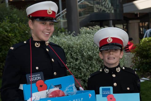 Royal Marine Cadets Jasmine Curtis and William Midgley selling poppies in Portsmouth this year