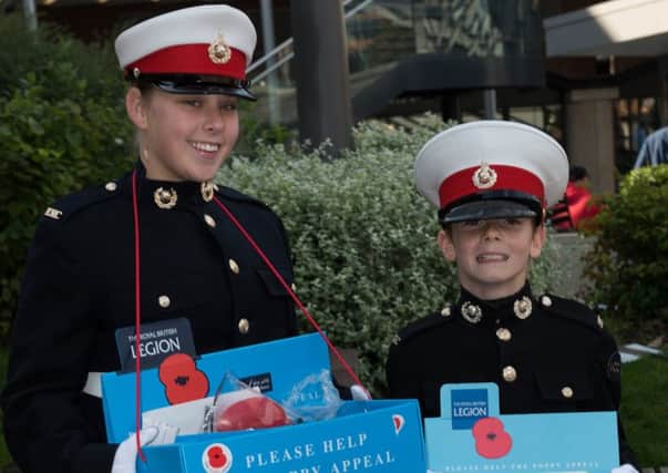 Royal Marine Cadets Jasmine Curtis and William Midgley selling poppies in Portsmouth this year