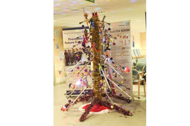 Staff at Queen Alexandra Hospital Fracture and Orthopaedic Clinic raise awareness of osteoporosis with their special Christmas tree made from walking crutches