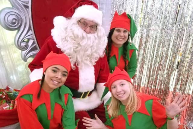 Santa Claus with his elves at Cascades Shopping Centre.
Picture: Kieran Davey