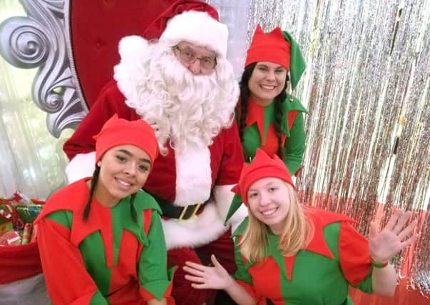 Santa Claus with his elves at Cascades Shopping Centre. 
Picture: Kieran Davey