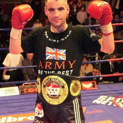 Tony Oakey celebrates after retaining his WBU light-heavyweight with victory over Neil Linford in 2003