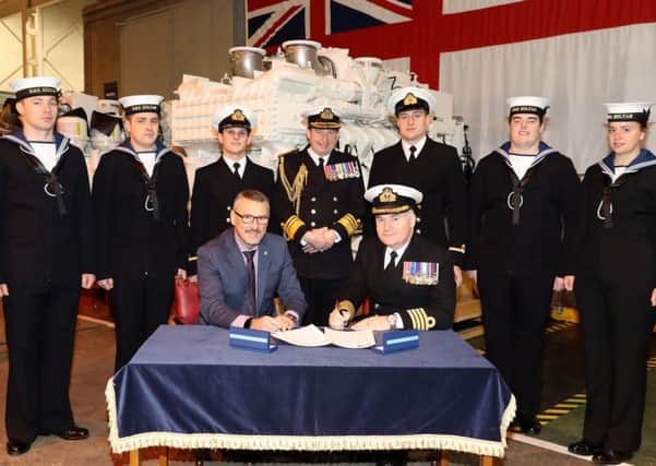 The signing of the agreement by Captain Peter Towell OBE and John Hilton Picture: PO Phot Nicola Harper