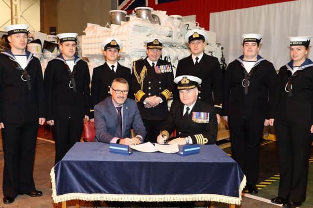 The signing of the agreement by Captain Peter Towell OBE and John Hilton Picture: PO Phot Nicola Harper