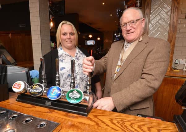 Deputy mayor of Havant Cllr Peter Wade pulls the first pint at the refurbished pub with general manager Emma Cupit