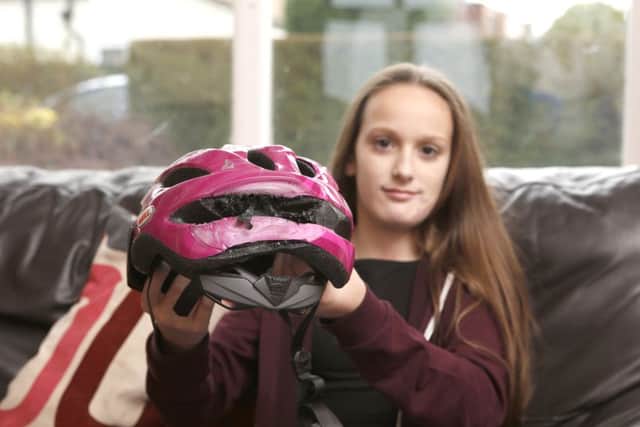 Maisie Godden-Hall 12 with the helmet that saved her at her home in Waterlooville.
Picture: Habibur Rahman (171672-141)