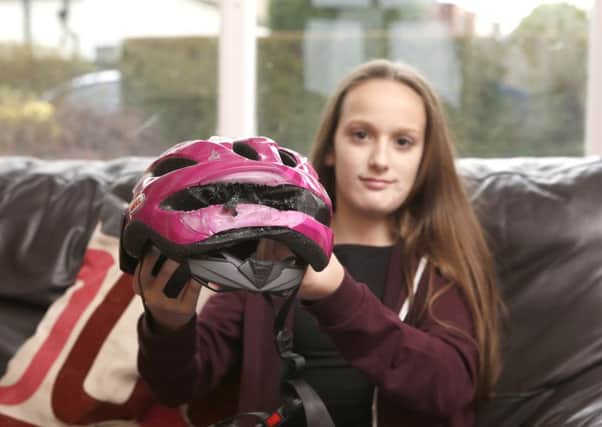 Maisie Godden-Hall 12 with the helmet that saved her at her home in Waterlooville.

Picture: Habibur Rahman (171672-141)