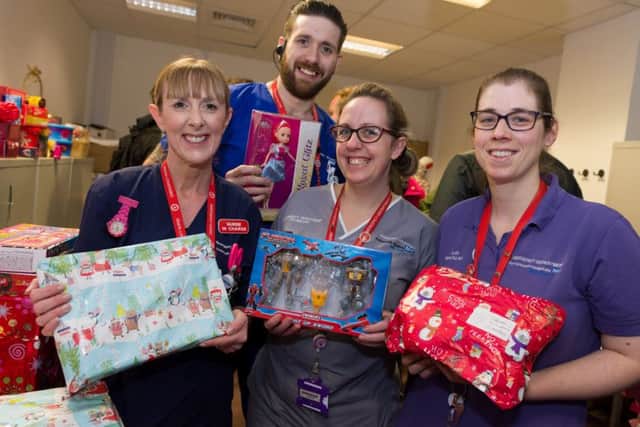 A motorbike group from the Park Tavern Pub in Gosport was one of the groups to visit QA with Christmas presents for patients and staff. From left, some of the grateful staff from the A7E unit - senior nurse Emma Tomkins, nurse Adam Mundell, student nurse Chrissie Ashton and play specialist Zoe Parton Picture: Duncan Shepherd