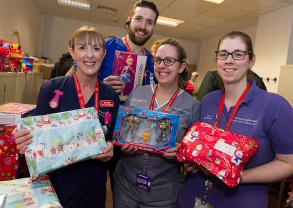 A motorbike group from the Park Tavern Pub in Gosport was one of the groups to visit QA with Christmas presents for patients and staff. From left, some of the grateful staff from the A7E unit - senior nurse Emma Tomkins, nurse Adam Mundell, student nurse Chrissie Ashton and play specialist Zoe Parton 
Picture: Duncan Shepherd