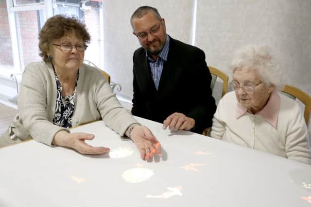 Kath Glanville, Cllr Luke Stubbs and Marie Dugan on the Tovertafel Picture: Habibur Rahmman
