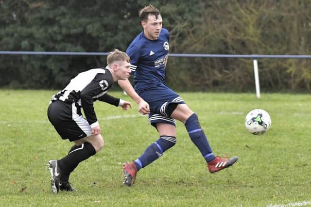 Danny Lane guides home Paulsgrove's opening goal in their match against Hayling United. Picture: Neil Marshall