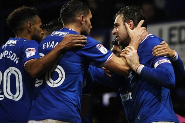 Brett Pitman, right, is congratulated after netting Pompey's winner. Picture: Joe Pepler