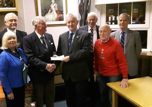 Dr David Sanders presents a cheque for Â£300 to Lt Col Gerry Corden, president of the local Royal Signals Association