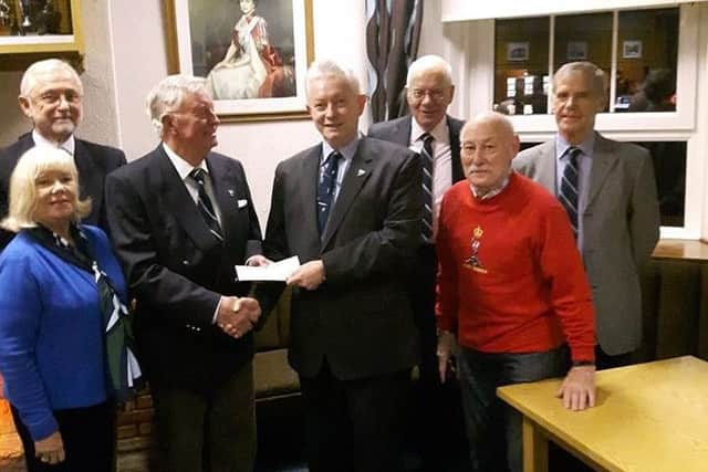 Dr David Sanders presents a cheque for Â£300 to Lt Col Gerry Corden, president of the local Royal Signals Association