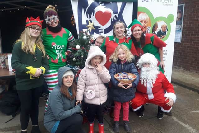 Kerry Snuggs, back right, with members of the Acts of Kindness Community, residents donating gifts, and Father Christmas. Picture: Eloise Appleby
