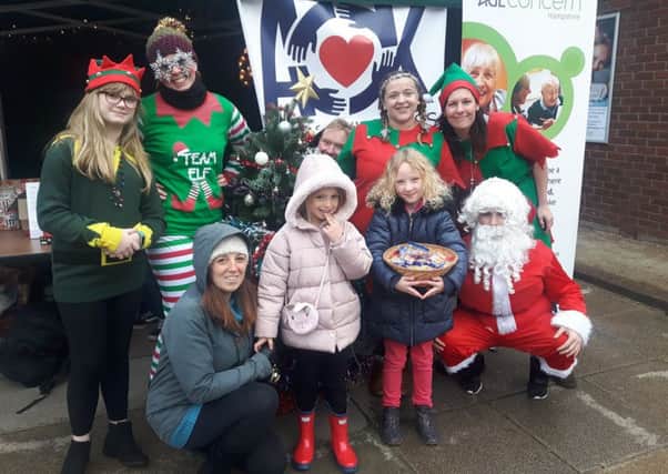 Kerry Snuggs, back right, with members of the Acts of Kindness Community, residents donating gifts, and Father Christmas. Picture: Eloise Appleby