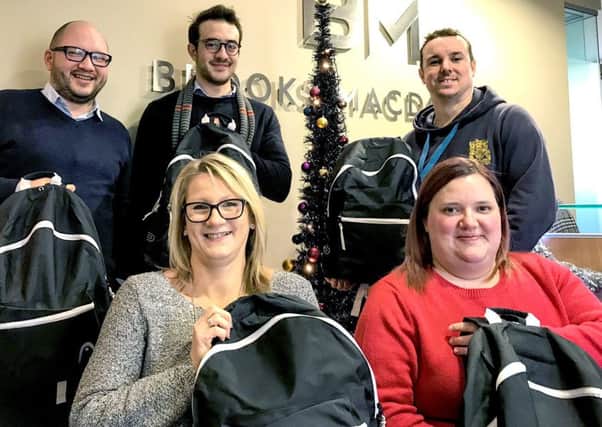 Brooks Macdonald donated rucksacks to Portsmouth charity The Lifehouse. Pictured (b
ack row) Russell Leggatt, Sami Kassou and James Place and (front row) Sally Spicer and Lizzie Cole
