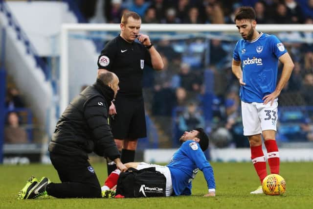 Danny Rose receives treatment on the pitch at Fratton Park yesterday Picture: Joe Pepler