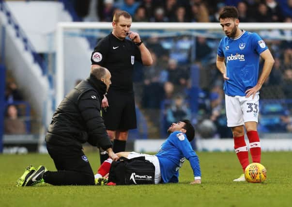 Danny Rose receives treatment on the pitch at Fratton Park yesterday Picture: Joe Pepler