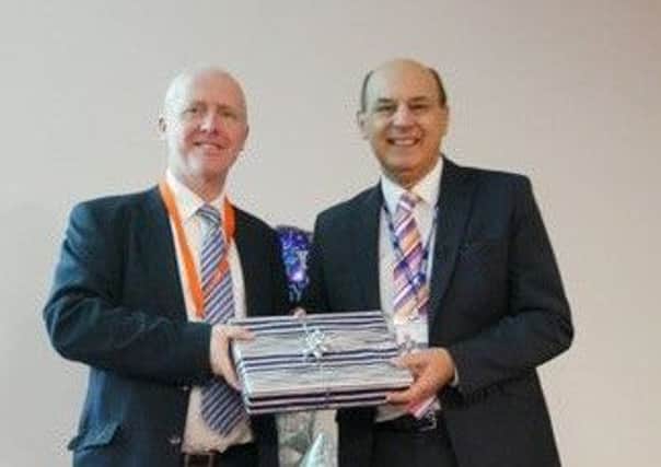 Nick Loader, left, chairman of PETA Ltd, presenting a farewell gift to Bob Hiskey