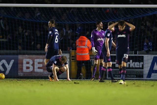 The Pompey players look dejected after Stuart Sinclair's goal at the Memorial Ground