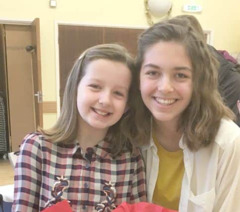 Jess Peett and her sister Chloe from All Saints Church, Catherington, with paper angels