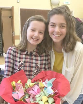 Jess Peett and her sister Chloe from All Saints Church, Catherington, with paper angels