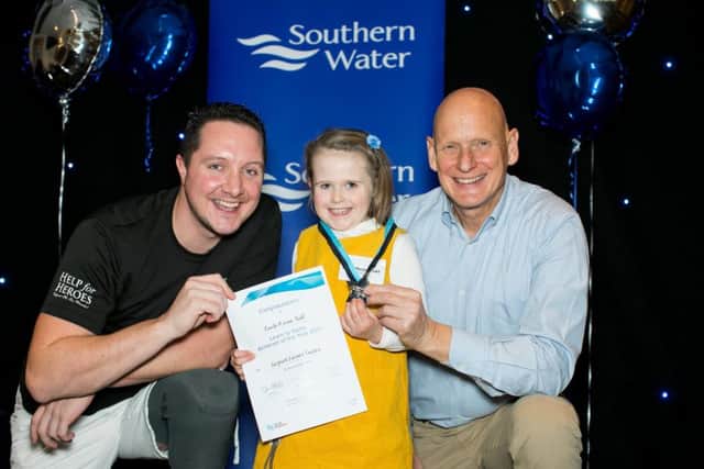 Enola-Reven Todd receives her award from Invictus Games gold medallist Mike Goody, left, and Olympic gold medallist Duncan Goodhew