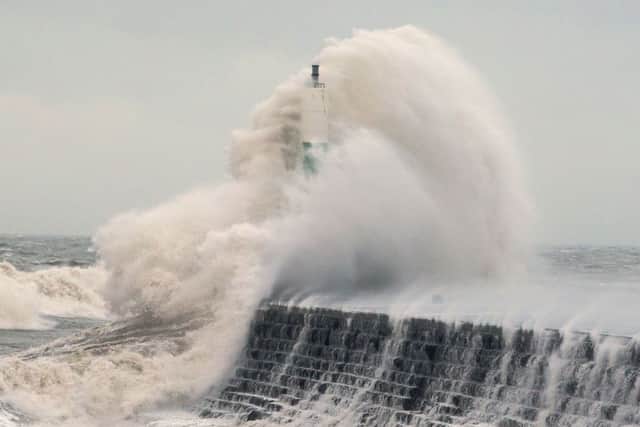 Waves crashing over the stone jetty wall in Aberystwyth in Wales yesterday, as a fresh warning of high winds has been issued for the majority of England and Wales today Picture: Aaron Chown/PA Wire