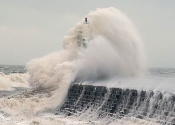 Waves crashing over the stone jetty wall in Aberystwyth in Wales yesterday, as a fresh warning of high winds has been issued for the majority of England and Wales today Picture: Aaron Chown/PA Wire