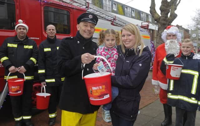 Firefighter Jasper Taylor with Claire Goldstone and her daughter Sophie (four), from Portchester.
 Picture: Ian Hargreaves
