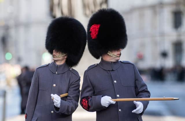Sgt Rupert Frere RLC - The Garrison Sergeant Major talks to a colleague ahead of the parade at the National Act of Remembrance at the Cenotaph in Whitehall