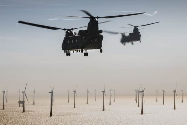 SAC Nicholas Egan RAF - Two Mk6 Chinooks crewed by 7 Sqn, based out of RAF Odiham, head out over North Sea wind farms during a low level insertion to retrieve a downed pilot during a rotary training exercise