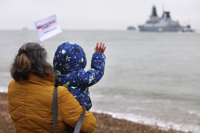 Charlotte Wright and her son Frank Wright, wave goodbye to PO Gary Wright as he departs on HMS Duncan. Picture: PO Phot Arron Hoare