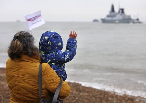Charlotte Wright and her son Frank Wright, wave goodbye to PO Gary Wright as he departs on HMS Duncan. Picture: PO Phot Arron Hoare