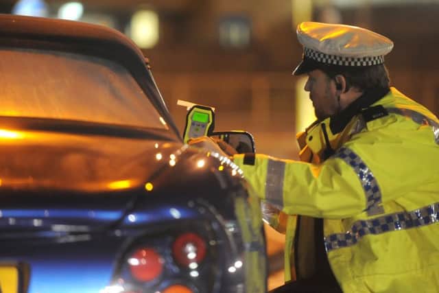 An officer stops a suspected drink-driver for a breath test